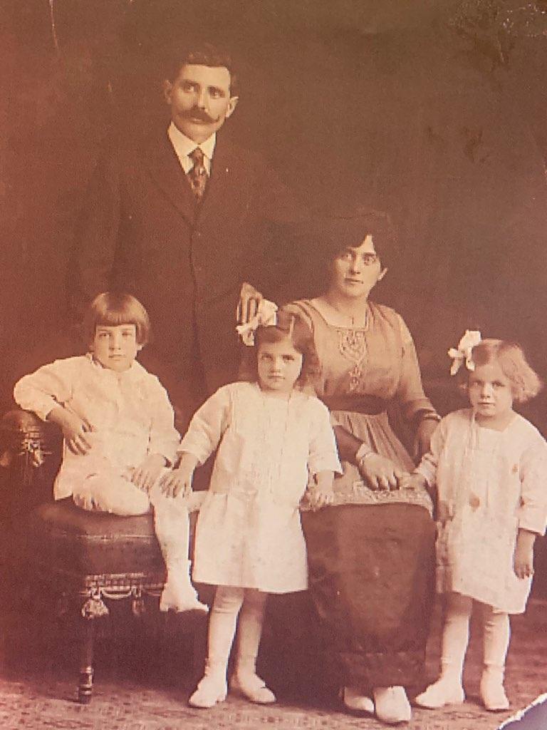 A vintage family portrait of Nandy and Assunta, with their children Max, Mary, and Ida.